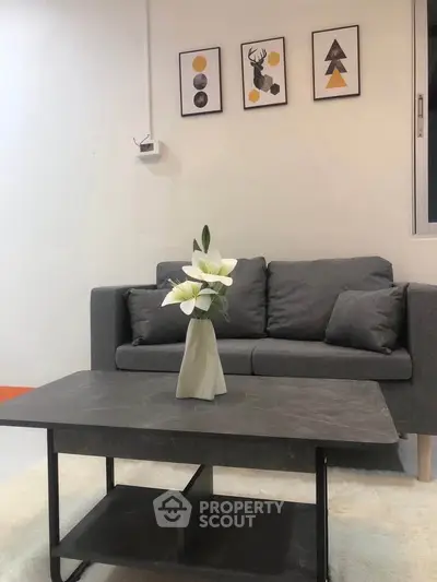 Modern living room with stylish gray sofa and elegant decor