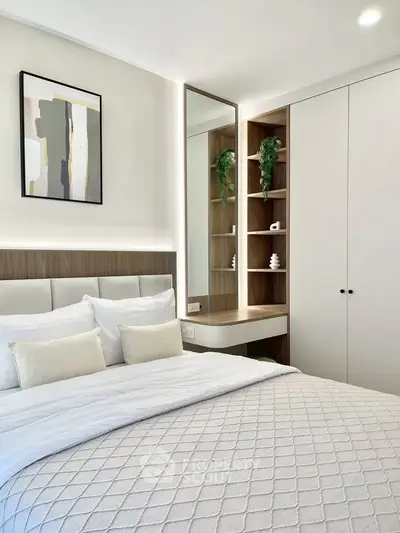 Modern bedroom with stylish decor and built-in storage, perfect for a cozy retreat.