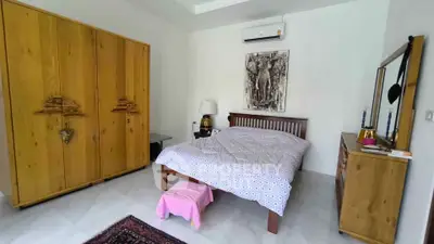 Cozy bedroom with wooden furniture and modern decor