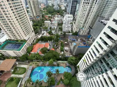 Stunning aerial view of urban residential complex with pool and lush greenery