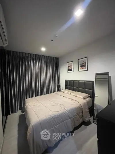 Modern bedroom with sleek design and cozy ambiance, featuring elegant curtains and stylish decor.