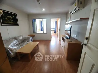 Cozy living room with wooden flooring and modern furniture in a stylish apartment.