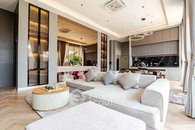 Luxurious open-plan living room with modern decor and ample natural light.