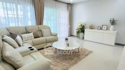 Elegant living room with plush sofa and modern decor, perfect for relaxation.