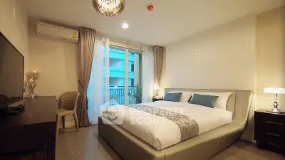 Luxurious bedroom with elegant decor and large window offering natural light.