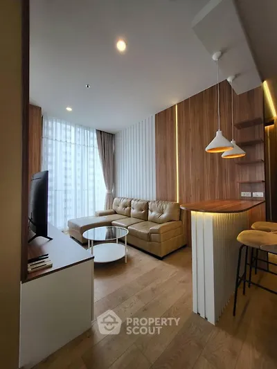 Modern living room with stylish decor, featuring a cozy sectional sofa and elegant lighting.