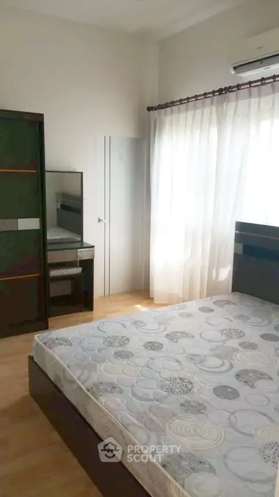 Bright and airy bedroom with modern furnishings and natural light.