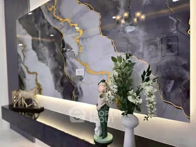 Luxurious living room with elegant marble wall and stylish decor