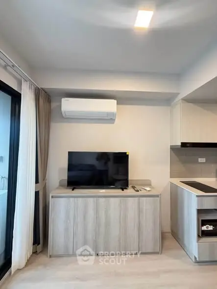 Modern living room with sleek TV setup and air conditioning in stylish apartment