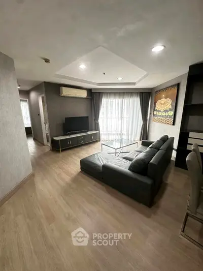 Spacious living room with modern decor and large windows for natural light.