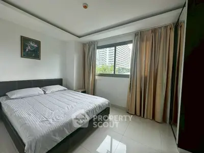 Modern bedroom with large window and city view, featuring sleek furniture and elegant curtains.