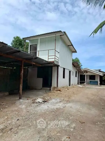 Charming two-story rural property with spacious outdoor area and potential for renovation.