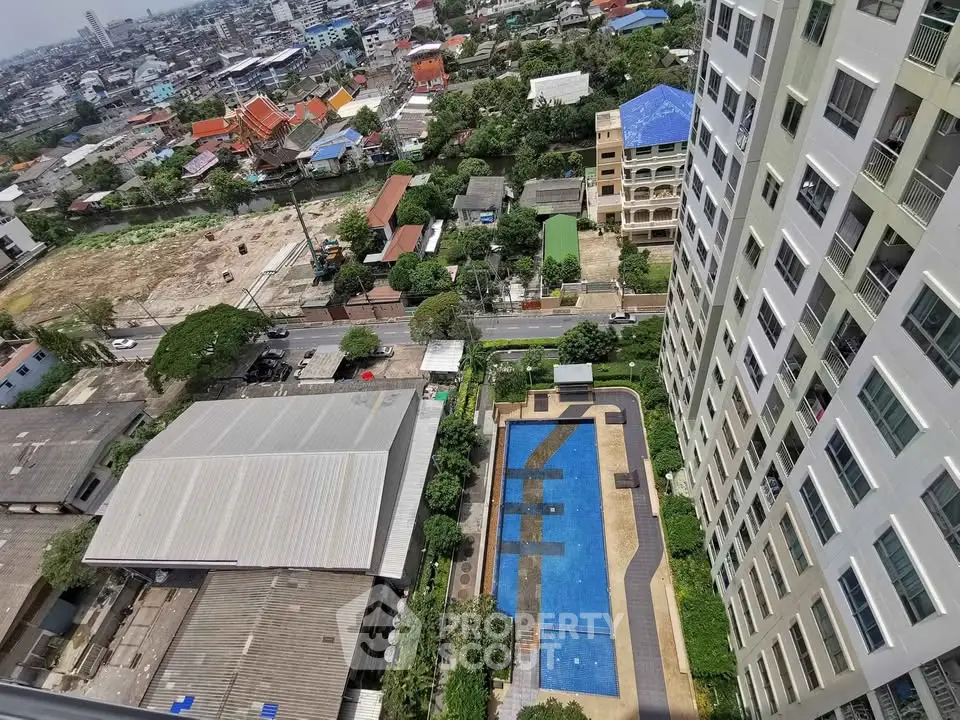 Stunning aerial view of modern high-rise building with pool and cityscape