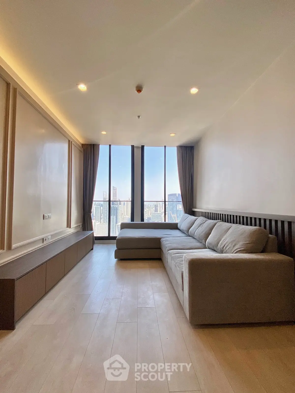 Spacious living room with panoramic city view and modern decor