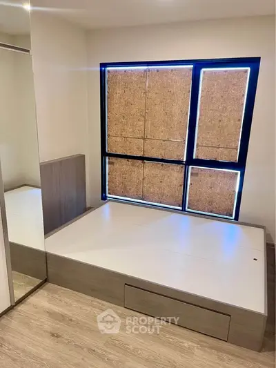Modern bedroom with built-in platform bed and mirrored closet doors