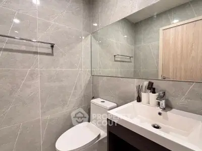 Modern bathroom with sleek fixtures and elegant tile design, perfect for a contemporary home.