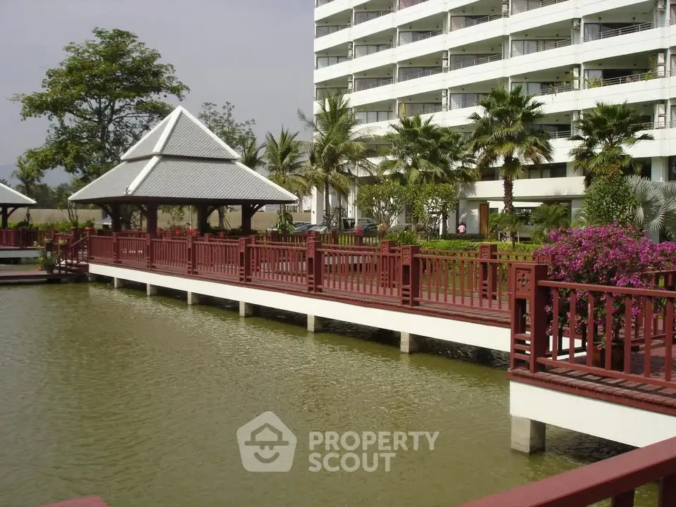 Stunning apartment building with serene water feature and lush landscaping
