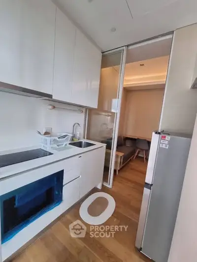 Modern compact kitchen with sleek white cabinetry and open layout