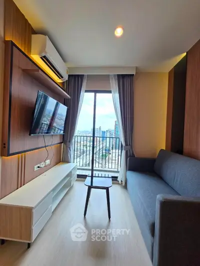 Modern living room with city view, sleek furniture, and large window for natural light.