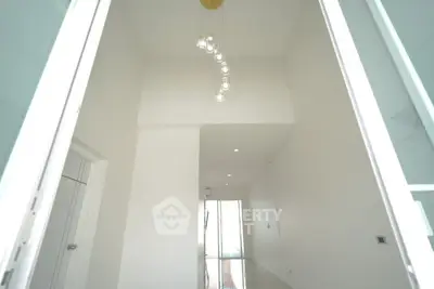 Elegant minimalist hallway with modern lighting and high ceiling