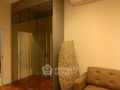 Modern living room with stylish decor and mirrored closet doors