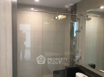 Modern bathroom with glass shower and sleek tile design