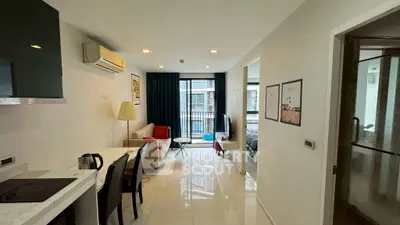 Modern open-plan living room with balcony view in stylish apartment