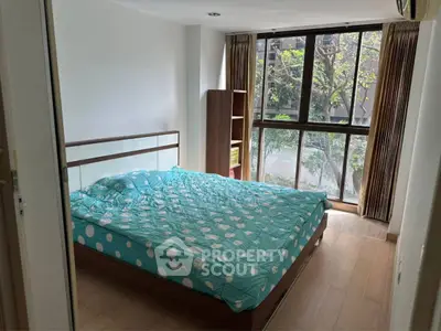 Spacious bedroom with large windows and modern decor