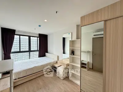 Modern bedroom with large window and stylish furniture in high-rise apartment