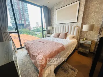 Elegant bedroom with large window offering city view, featuring stylish decor and cozy bedding.