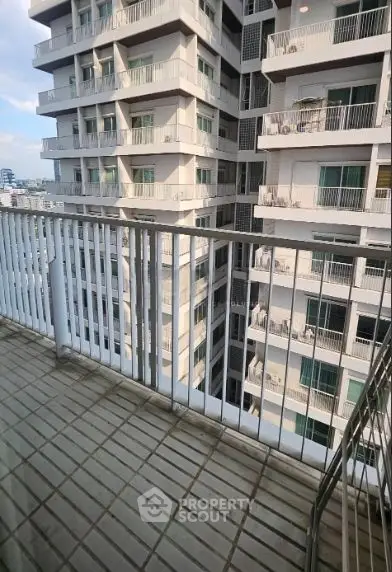 Spacious balcony with city view in modern high-rise building