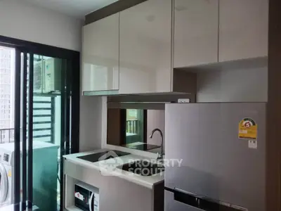Modern kitchen with sleek appliances and balcony view