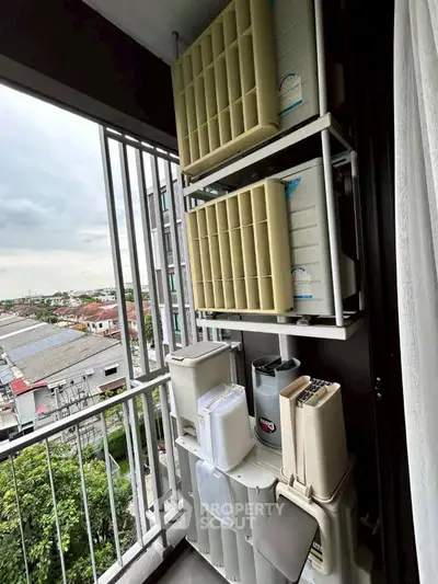Compact balcony with storage containers and city view