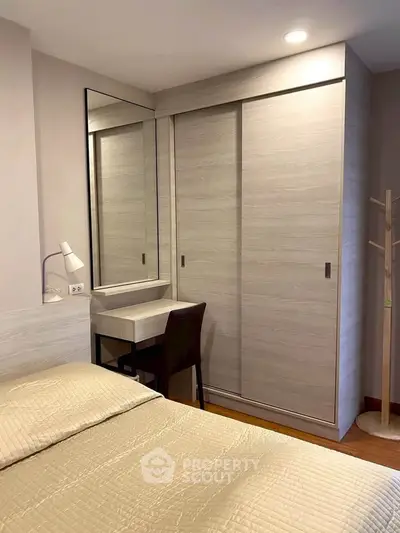 Cozy bedroom with modern wardrobe and study desk