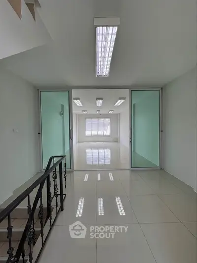 Spacious modern office space with glass partitions and bright lighting