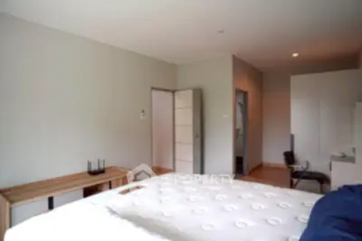 Spacious bedroom with modern furniture and neutral decor