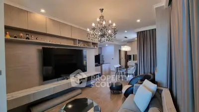 Luxurious living room with elegant chandelier and modern decor in a stylish apartment.