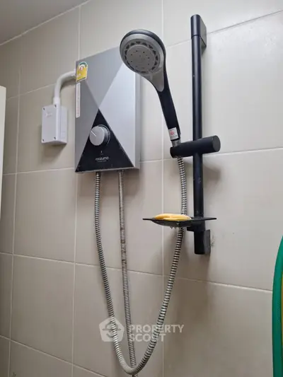 Modern bathroom with sleek showerhead and water heater on tiled wall.