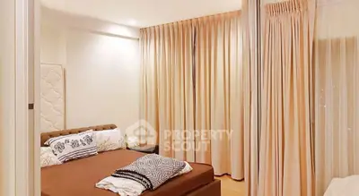 Cozy bedroom with elegant curtains and stylish bedding in modern apartment