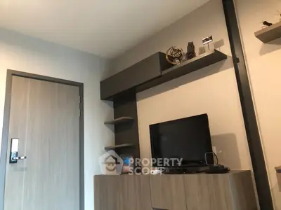 Modern living room with sleek TV stand and stylish shelving in a contemporary apartment.