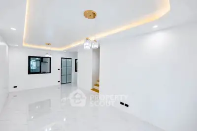 Modern minimalist living room with elegant lighting and glossy white tiles