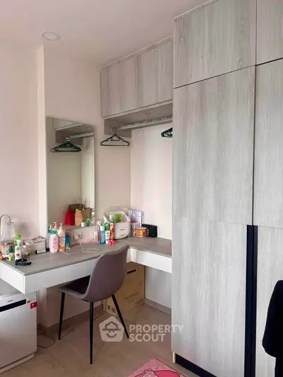 Modern bedroom with sleek wardrobe and stylish vanity desk