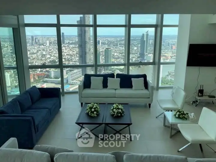 Luxurious living room with panoramic city view and modern furnishings.
