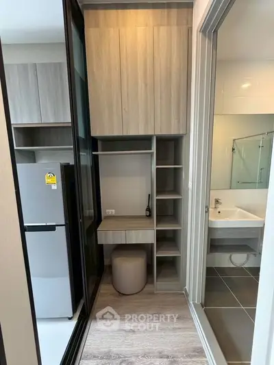 Modern apartment with sleek kitchen and bathroom, featuring stylish cabinetry and contemporary design.
