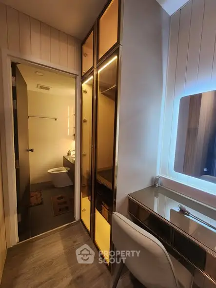 Modern bathroom with sleek design and illuminated mirror in stylish apartment.