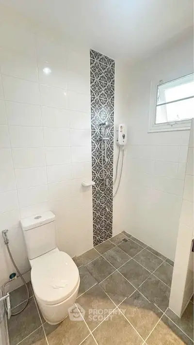 Modern bathroom with tiled walls and shower heater
