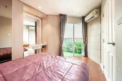 Cozy bedroom with balcony access and elegant decor