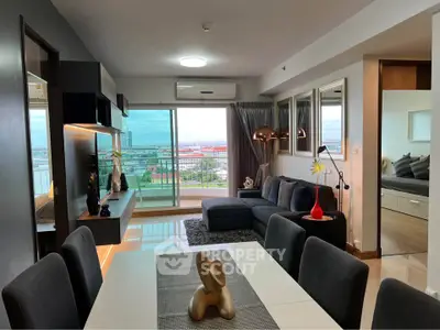 Modern living room with city view, stylish decor, and open layout in a high-rise apartment.