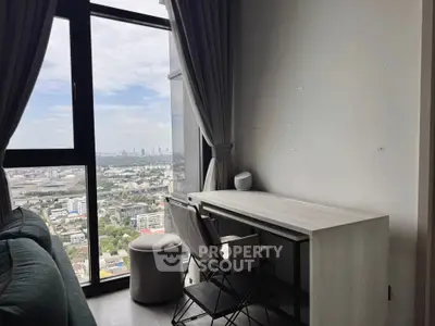 Modern study area with stunning city view from high-rise apartment window.