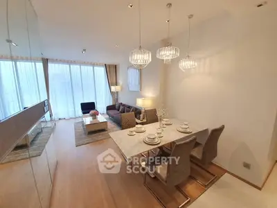 Luxurious open-plan living and dining area with elegant lighting and modern decor.
